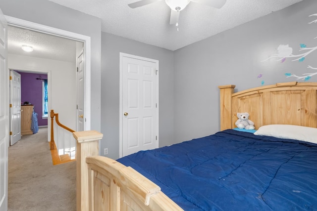 bedroom with light carpet, a textured ceiling, and ceiling fan