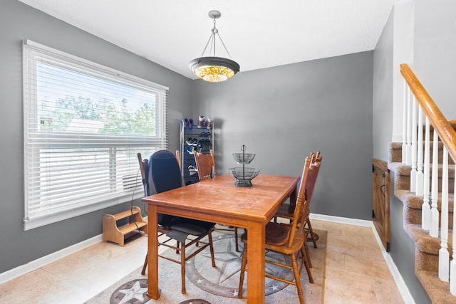 dining room with stairs and baseboards