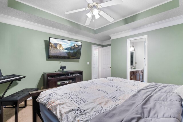 carpeted bedroom featuring ceiling fan, ornamental molding, and ensuite bath