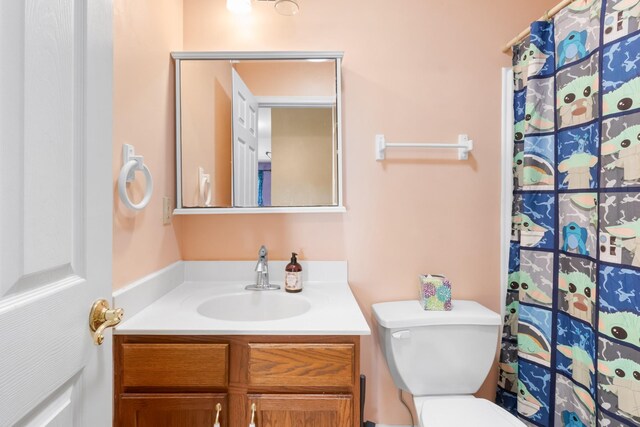 bathroom featuring toilet and vanity