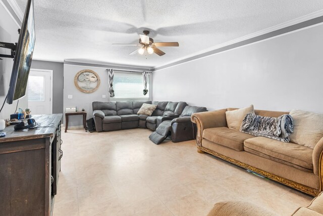 living room with a textured ceiling, ceiling fan, and ornamental molding