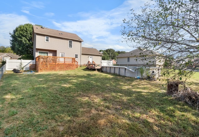 view of yard with a fenced backyard, a fenced in pool, and a wooden deck