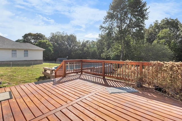 wooden deck with a yard and fence