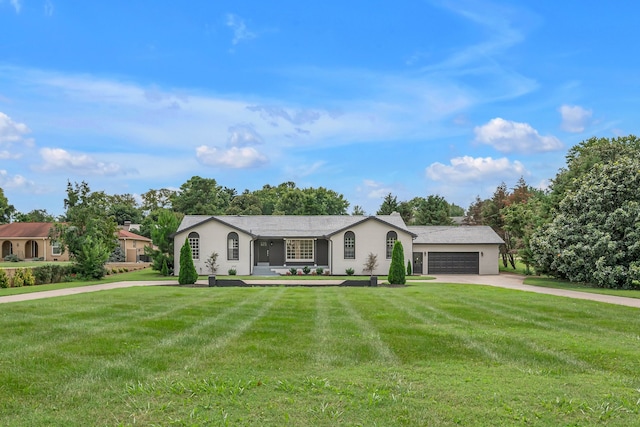 single story home with a garage and a front lawn