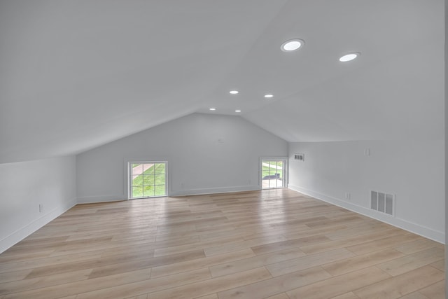 bonus room with lofted ceiling and light hardwood / wood-style floors