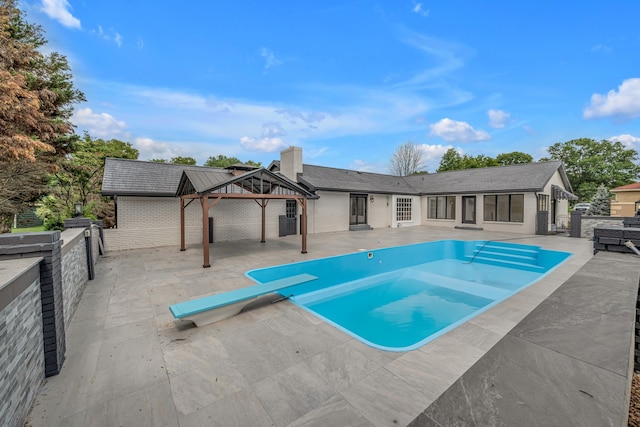 view of swimming pool with a patio and a gazebo