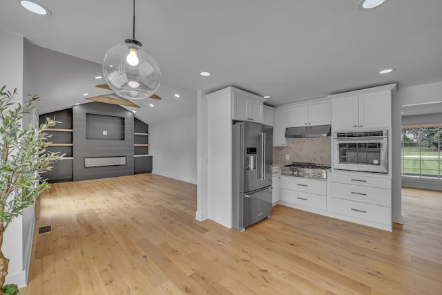 kitchen with pendant lighting, light hardwood / wood-style floors, white cabinetry, vaulted ceiling, and stainless steel appliances