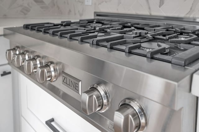 details featuring stainless steel stove and backsplash