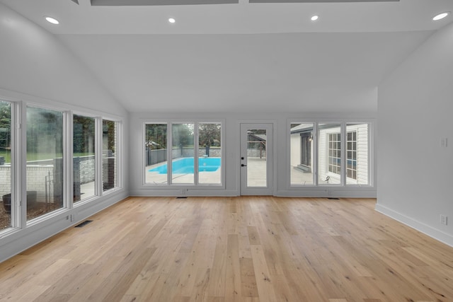 unfurnished living room featuring light hardwood / wood-style floors and high vaulted ceiling