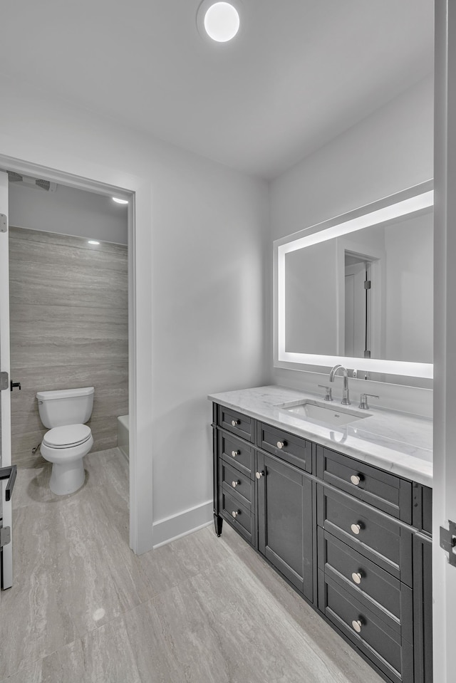 bathroom featuring hardwood / wood-style flooring, vanity, and toilet