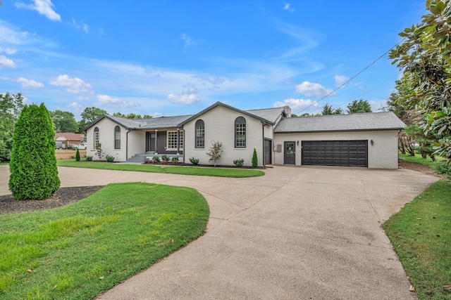 single story home featuring a garage and a front lawn