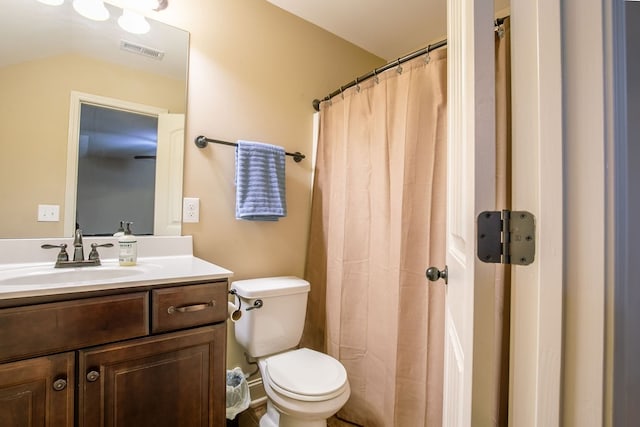 bathroom featuring vanity, toilet, and a shower with shower curtain