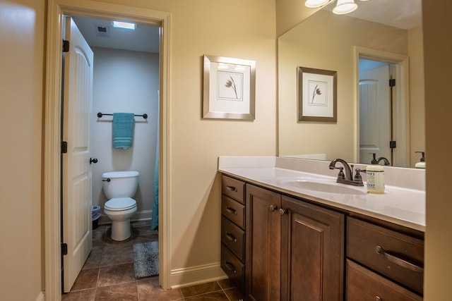 bathroom with vanity, toilet, and tile patterned floors