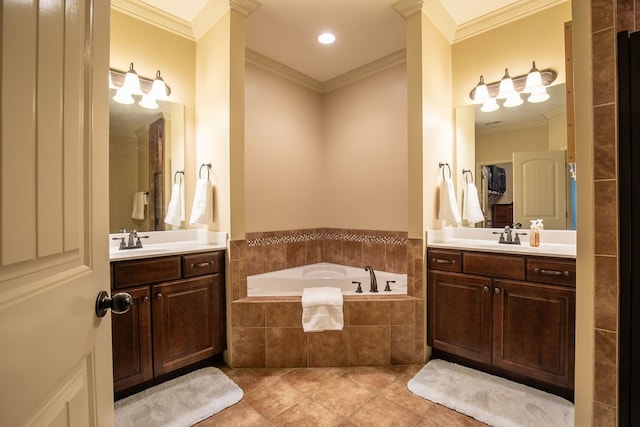 bathroom featuring tile patterned floors, tiled tub, crown molding, and vanity