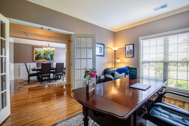 home office with crown molding, hardwood / wood-style flooring, and an inviting chandelier