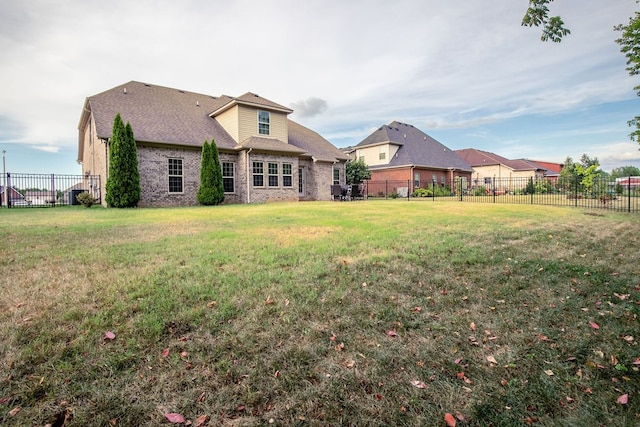 rear view of property featuring a yard