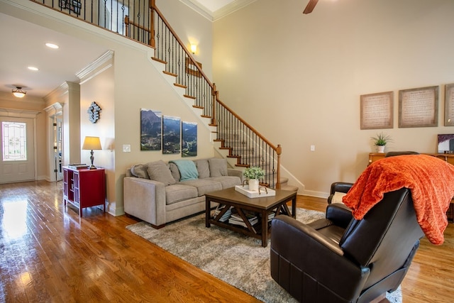 living room featuring ceiling fan, ornamental molding, and hardwood / wood-style floors