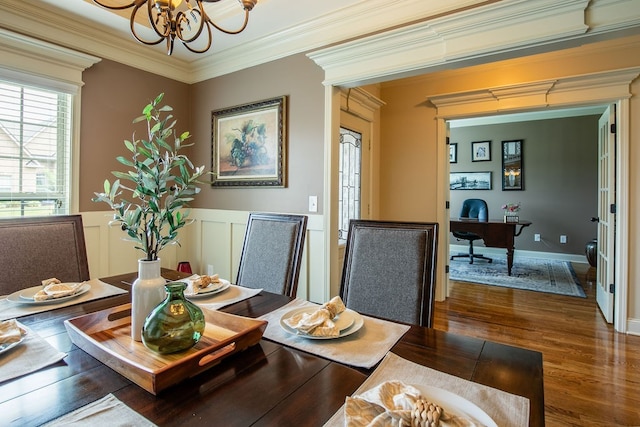 dining room with ornamental molding, a chandelier, and dark hardwood / wood-style flooring