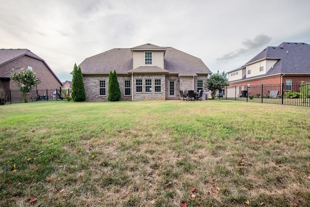 rear view of property with a yard