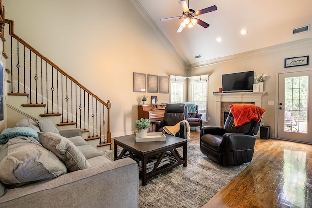 living room featuring plenty of natural light, ceiling fan, hardwood / wood-style floors, and high vaulted ceiling