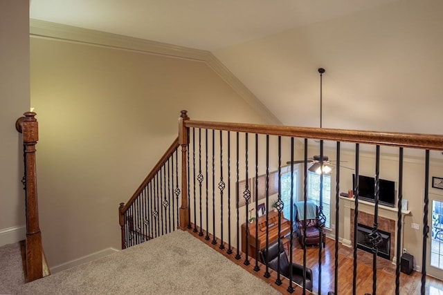 staircase with ceiling fan, plenty of natural light, and ornamental molding