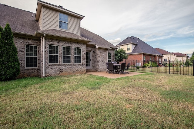 back of property featuring a yard and a patio