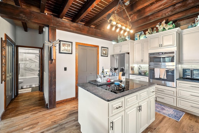 4818 Ensor Hollow Rd, Buffalo Valley, TN 38548 - kitchen featuring stainless steel appliances, light wood-style flooring, wooden ceiling, beam ceiling, and a kitchen island