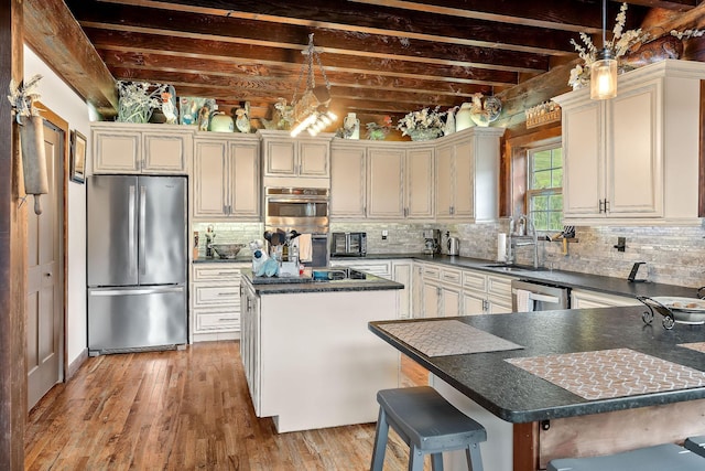 4818 Ensor Hollow Rd, Buffalo Valley, TN 38548 - kitchen with backsplash, dark countertops, stainless steel appliances, and a kitchen island