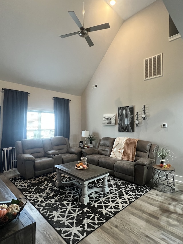 living room with high vaulted ceiling, ceiling fan, and hardwood / wood-style floors