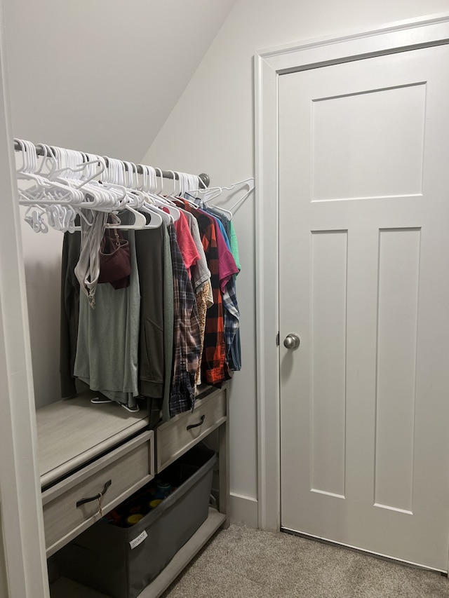 mudroom with light carpet and vaulted ceiling