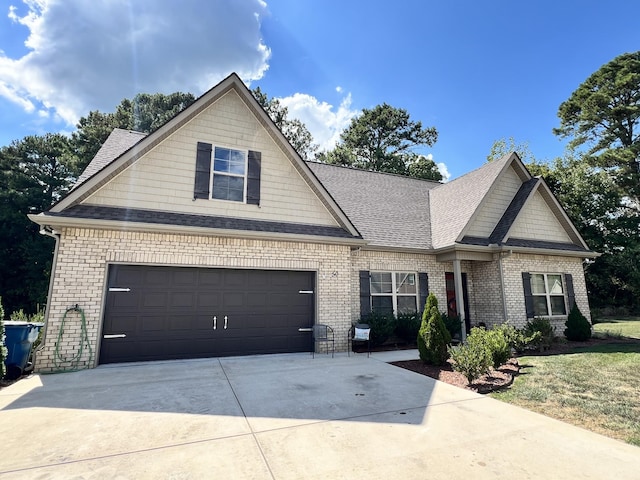 craftsman inspired home with brick siding, driveway, and a shingled roof