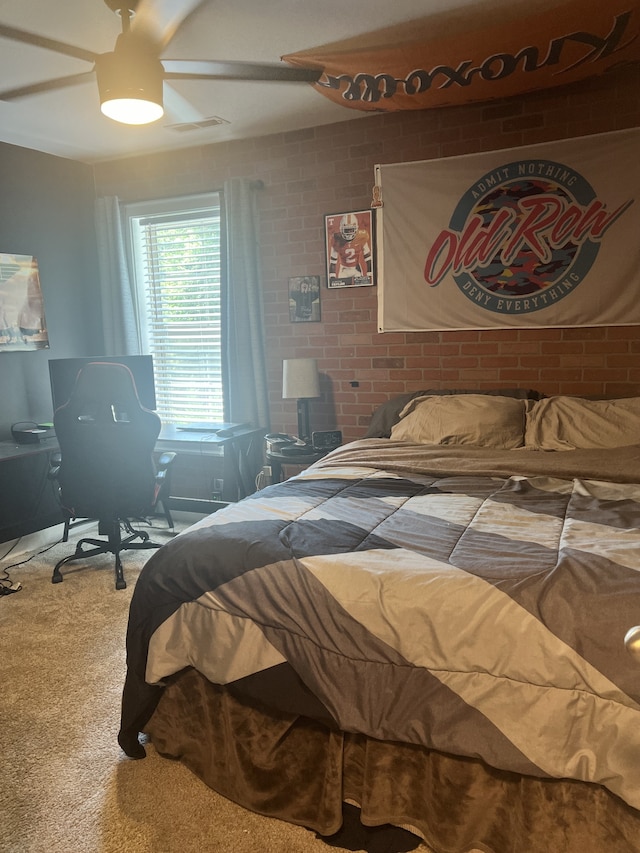 bedroom with carpet flooring, ceiling fan, and brick wall