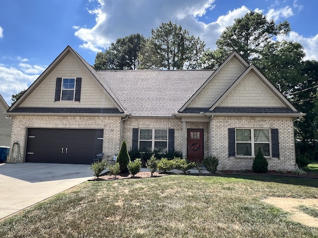 craftsman-style home featuring a garage and a front lawn