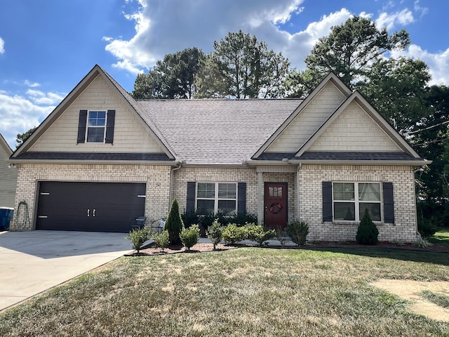 craftsman-style home featuring brick siding, concrete driveway, a front lawn, and a shingled roof