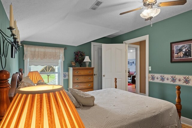 bedroom featuring a textured ceiling, ceiling fan, and wood-type flooring