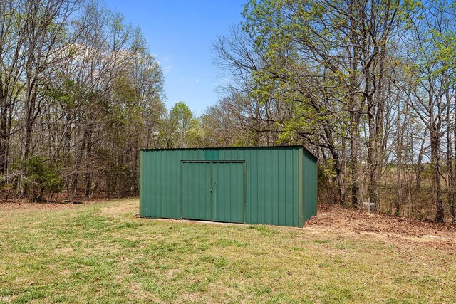 view of outbuilding with a lawn