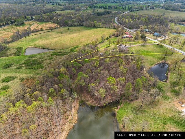 drone / aerial view featuring a water view and a rural view