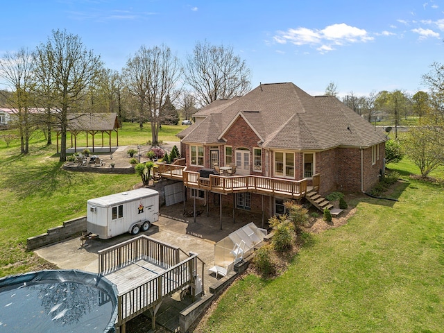 back of house featuring a deck, a lawn, a patio, and a gazebo