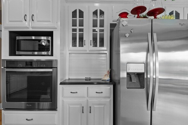 kitchen featuring stainless steel appliances and white cabinetry