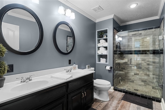 bathroom featuring a textured ceiling, vanity, a shower with shower door, wood-type flooring, and toilet