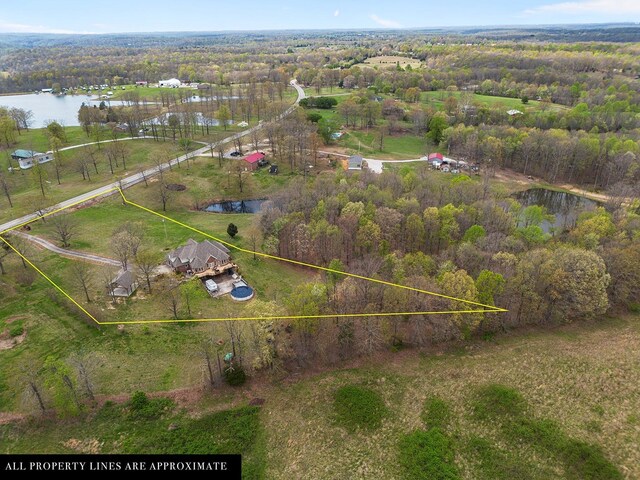 birds eye view of property featuring a water view and a rural view