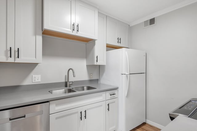 kitchen featuring dishwasher, white cabinetry, crown molding, and sink