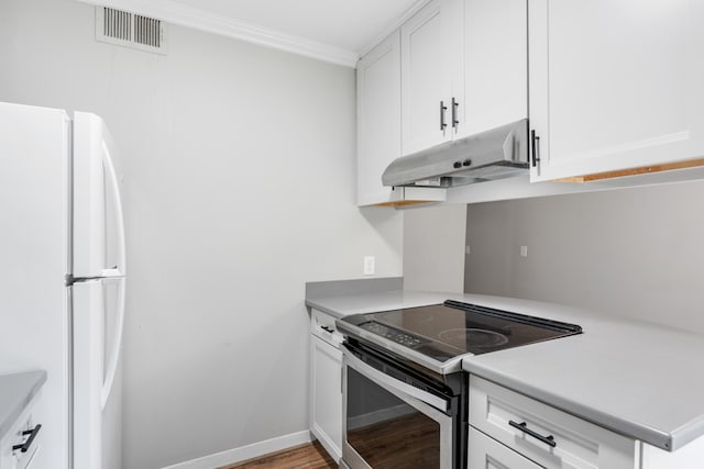 kitchen with crown molding, white cabinetry, and stainless steel range with electric stovetop