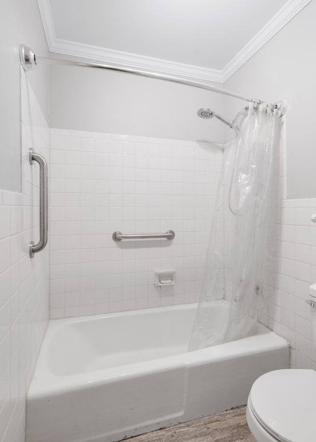 bathroom featuring hardwood / wood-style floors, toilet, tile walls, shower / tub combo with curtain, and ornamental molding