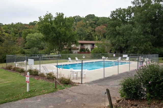 view of swimming pool featuring a yard