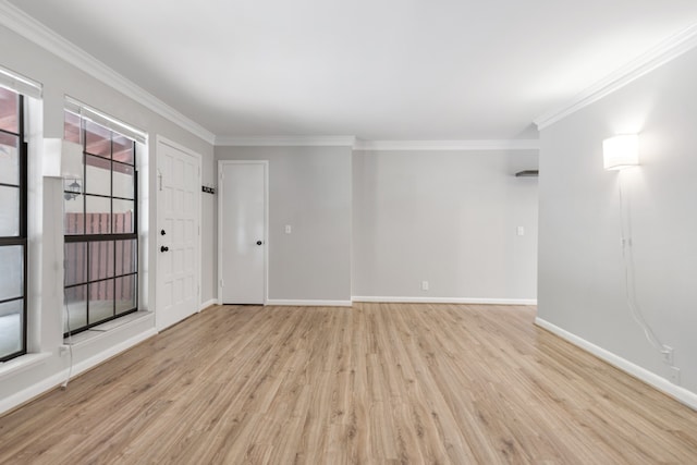 spare room with crown molding and light hardwood / wood-style flooring