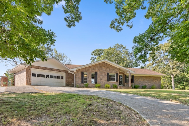 single story home with a garage and a front lawn