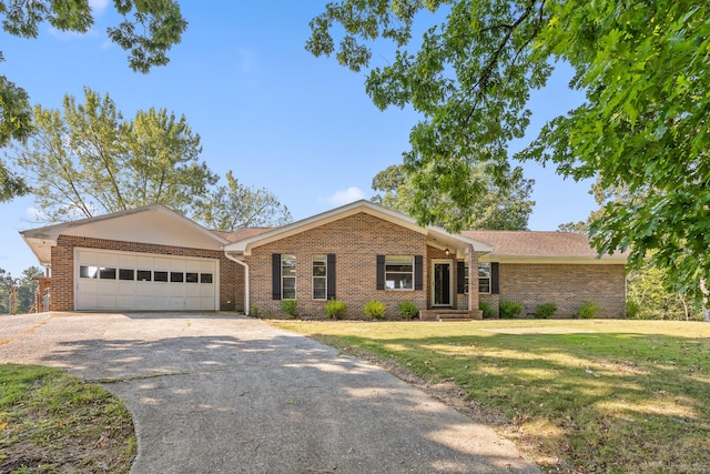 ranch-style home with a garage and a front yard