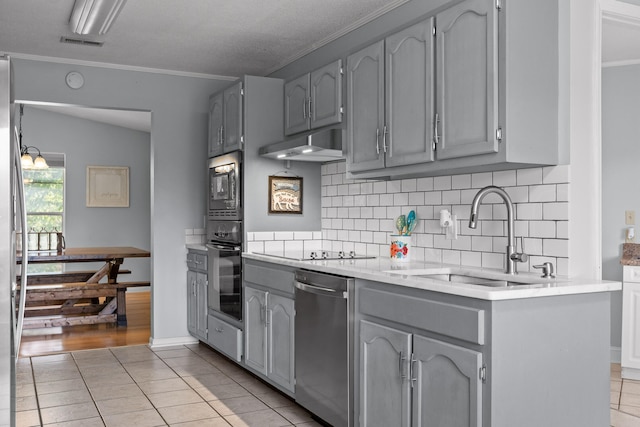 kitchen with black appliances, gray cabinetry, and light hardwood / wood-style flooring