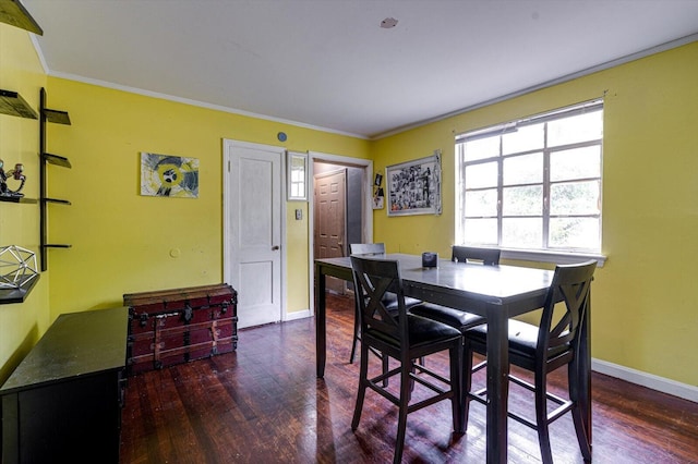 dining area featuring ornamental molding and dark hardwood / wood-style floors